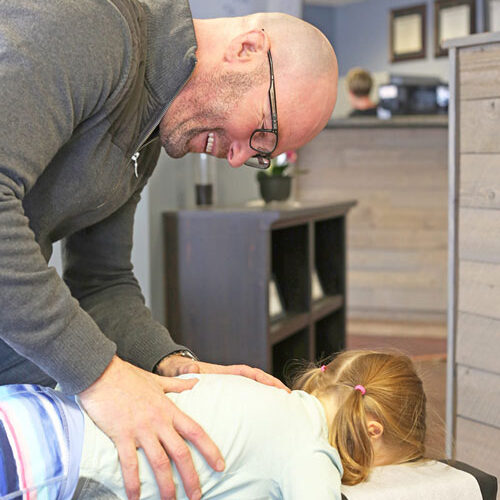 Chronic Pain Libertyville IL Steve Burlison doing an adjustment on a child Chronic Pain Libertyville IL Steve Burlison doing an adjustment on a child